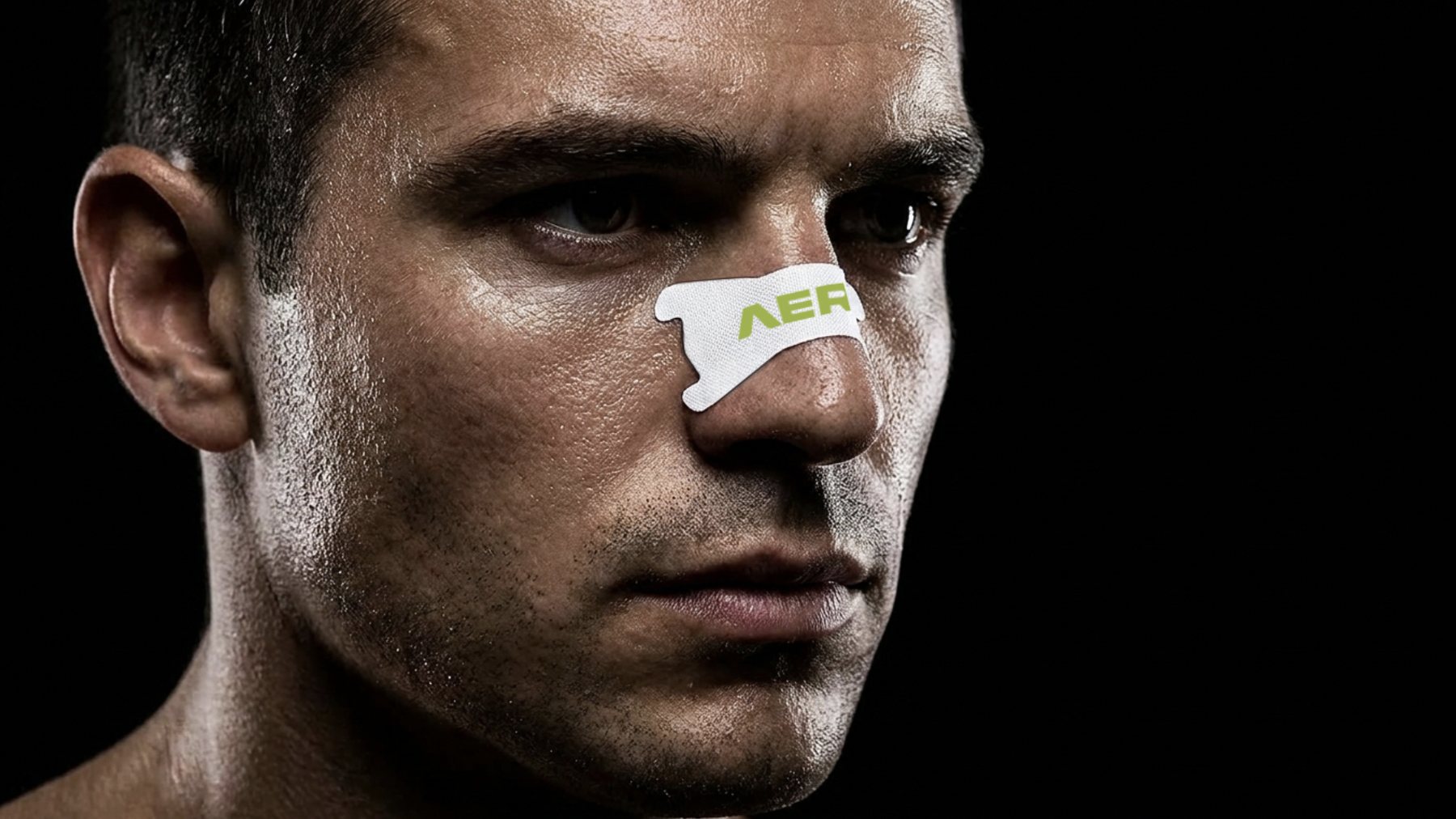 AERO2 volt-green nasal strip applied on an athlete's nose, dramatic low-key studio lighting