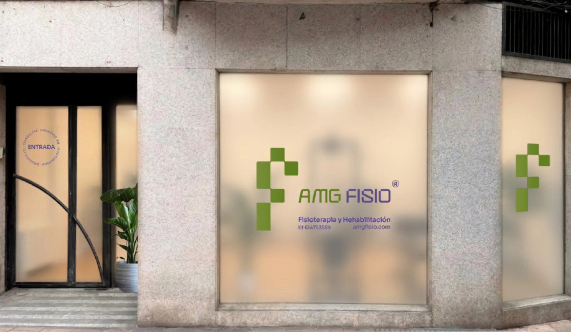 AMG Fisio storefront, the built design: green isotype and green and purple wordmark on frosted glass, with the ENTRADA decal on the door