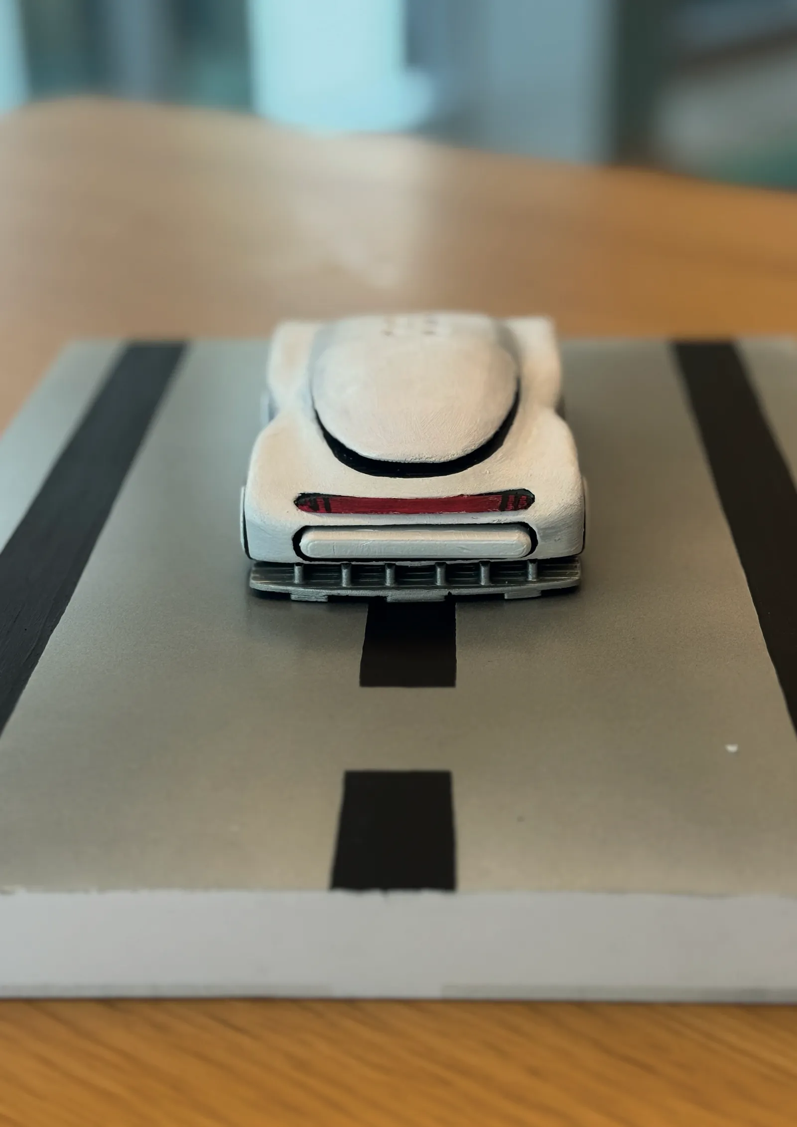 Rear view of the printed car on the diorama plate with red light strip and diffuser