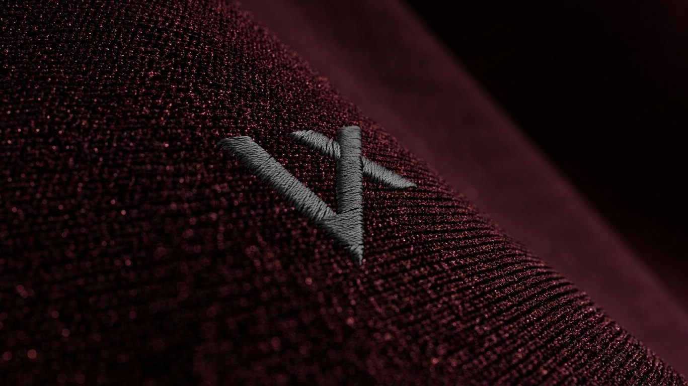 VELOQUE wordmark embroidered on a winter cycling garment, close detail of the stitching