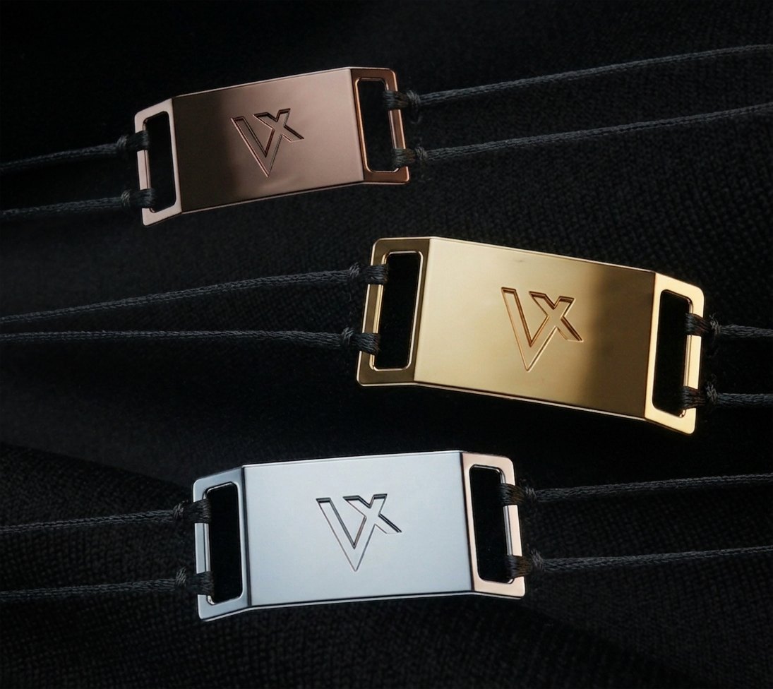 VELOQUE metal brand ornaments applied to a jersey and a winter jacket