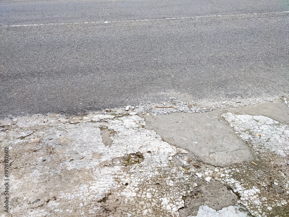 Broken curb cut and obstacle on a sidewalk